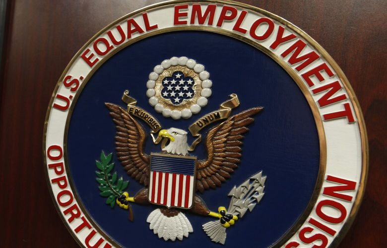 The emblem of the U.S. Equal Employment Opportunity Commission is shown on a podium in Vail, Colo. Washington workers may soon see the impacts of a key federal employee rights watchdog’s plans to roll back anti-discrimination protections, particularly for transgender people. (David Zalubowski / The Associated Press, 2016)