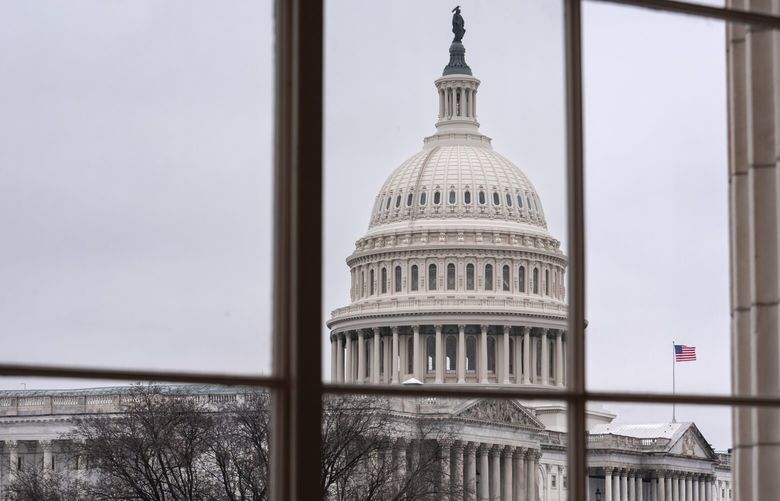 The Capitol is seen framed through a window in the Cannon House Office Building on Capitol Hill in Washington, Thursday, Feb. 13, 2025. (AP Photo/J. Scott Applewhite) DCSA114 DCSA114