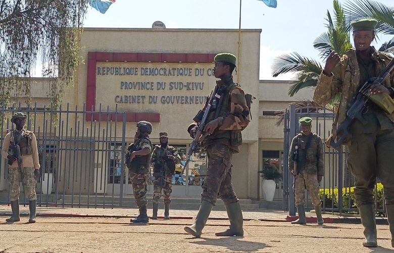 M23 rebels guard outside the South Kivu province administrative office, at the centre of east Congo’s second-largest city, Bukavu, Sunday, Feb. 16, 2025. (AP Photo/Janvier Barhahiga) BUK102 BUK102