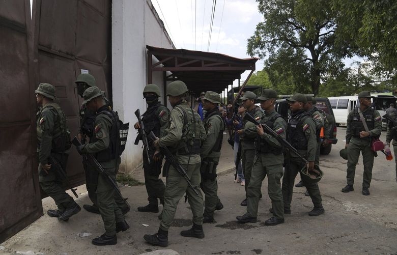FILE – Soldiers raid the Tocorón Penitentiary Center, where the Tren de Aragua gang originated, in Tocorón, Venezuela, Sept. 20, 2023. (AP Photo/Ariana Cubillos, File) XLM307 XLM307
