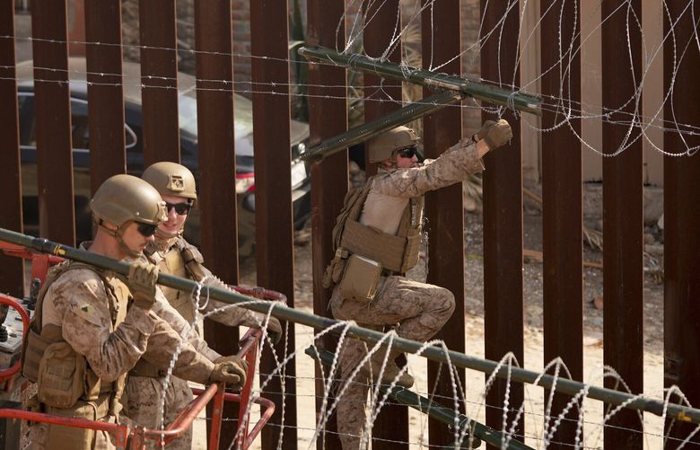 U.S. Marines install barbed wire along the border fence Friday, Jan. 31, 2025, in San Diego. (AP Photo/Jae C. Hong) LA563 LA563