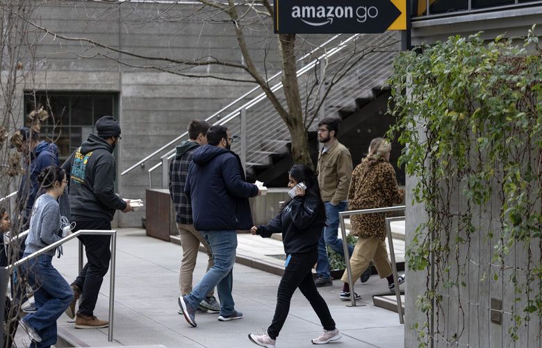People come and go from an Amazon office in South Lake Union during lunch hour on Monday, Jan. 6, 2025, in Seattle.