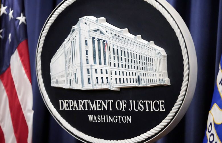 FILE – The logo for the Justice Department is seen before a news conference at the Department of Justice, Aug. 23, 2024, in Washington. (AP Photo/Mark Schiefelbein, File) WX103 WX103