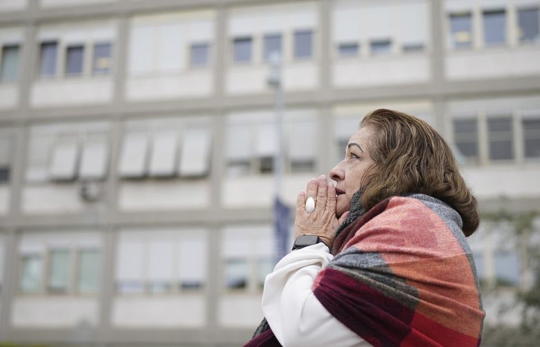 A woman prays at the Agostino Gemelli Polyclinic, in Rome, Monday, Feb. 24, 2025 where Pope Francis is hospitalized since Friday, Feb. 14. (AP Photo/Alessandra Tarantino) ALT106 ALT106