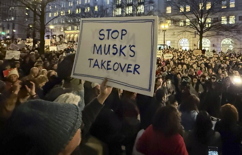 FILE – People protest during a rally outside the Treasury Department in Washington, Feb. 4, 2025. (AP Photo/Jose Luis Magana, File) WX201 WX201
