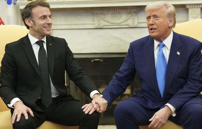 President Emmanuel Macron of France, left, holds President Donald Trump’s hand as they meet in the Oval Office of the White House in Washington, on Monday, Feb, 24, 2025. Macron and Prime Minister Keir Starmer of the United Kingdom are scheduled to meet with Trump in Washington this week, part of an effort to make sure that Europe is not excluded from peace talks with Russia to end the war in Ukraine. (Doug Mills/The New York Times) XNYT0873 XNYT0873