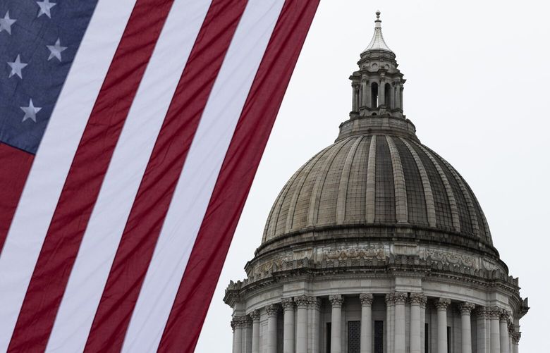 A large American flag is hung by the Washington Public Utility Districts Association (WPUDA) near the Washington State Capitol for a day of lobbying by the WPUDA, Thursday, Feb. 13, 2025, in Olympia.