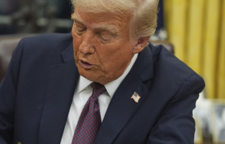 FILE – President Donald Trump signs an executive order on birthright citizenship in the Oval Office of the White House in Washington, Jan. 20, 2025. (AP Photo/Evan Vucci, File) XAB190 XAB190