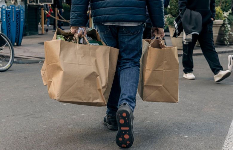 A shopper carries bags outside Macy’s flagship store in New York, US, on Sunday, Dec. 8, 2024. US consumer borrowing increased in October by more than forecast, reflecting the largest advance in credit-card balances since mid-2022. Photographer: Jeenah Moon/Bloomberg