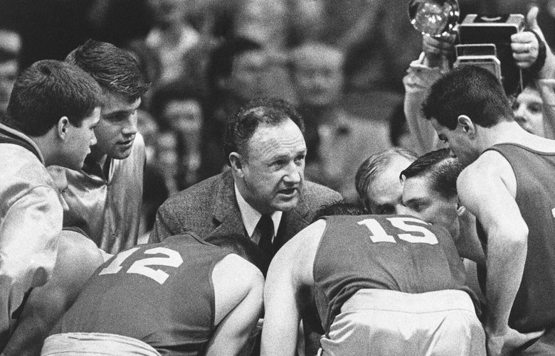 FILE – Actor Gene Hackman gives fictional Hickory High basketball players instructions during filming of the final game of the movie “Hoosiers” at Hinkle Fieldhouse on the Butler University campus, Friday, Dec. 6, 1985 in Indianapolis. (AP Photo/Tom Strickland, File) HACK104 HACK104