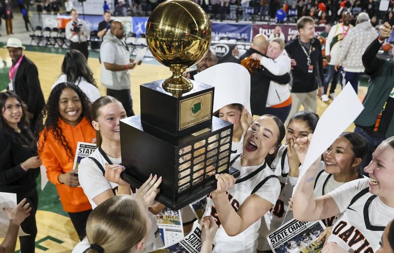 Davis High celebrate a mission complete after winning the Class 4A Washington State Basketball Championship Saturday evening in Tacoma, Washington, on March 8, 2025. Davis won 61-45. 229454