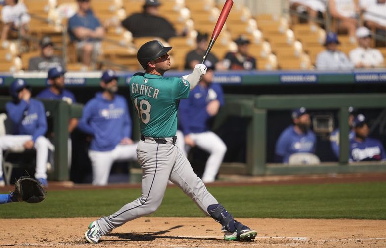 Seattle Mariners’ Mitch Garver hits a home run during the third inning of a spring training baseball game against the Los Angeles Dodgers, Tuesday, Feb. 25, 2025, in Phoenix. (AP Photo/Ashley Landis) LAD266 LAD266