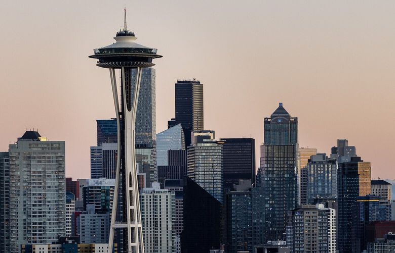 The sun sets on downtown Seattle and Mount Rainier on Sunday, Jan. 19, 2025.