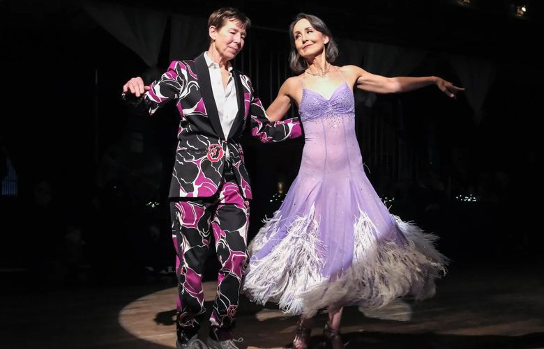 Century Ballroom owner Hallie Kuperman and longtime Century Ballroom dance instructor Alison Cockrill take center stage during the Masquerade Waltz in January. (Dean Rutz / The Seattle Times)