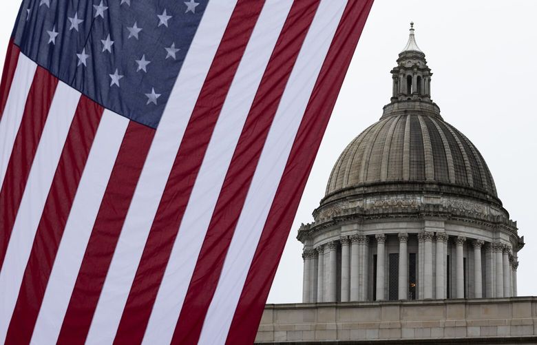A large American flag is hung by the Washington Public Utility Districts Association (WPUDA) near the Washington State Capitol for a day of lobbying by the WPUDA, Thursday, Feb. 13, 2025, in Olympia.