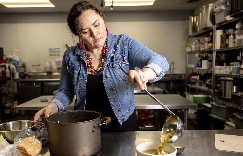 Vicky Garcia, owner of Rice, Beans & Happiness, dishes up a bowl of pozole on Monday, March 3, 2025, in Redmond.