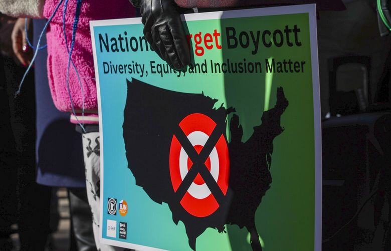 A community member holds a sign calling for a national boycott of Target stores during a news conference outside Target Corporation’s headquarters Thursday, Jan. 30, 2025, in Minneapolis, Minn.