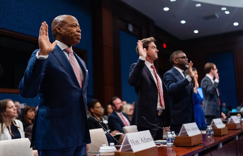 Mayor Eric Adams of New York, left, is sworn in with other Democratic mayors at the start of a hearing on “sanctuary cities” before the House Committee on Oversight and Government Reform in Washington on Wednesday, March 5, 2025. Republicans accused the mayors of New York, Chicago, Denver and Boston of providing sanctuary to criminals, while Democrats pointed to falling crime rates and defended helping the needy. (Eric Lee/The New York Times) XNYT0213 XNYT0213