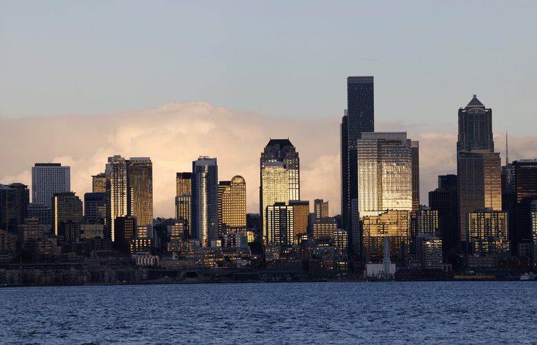 Buildings are illuminated by a setting sun in Seattle, seen from West Seattle, on Friday, November 15, 2024.