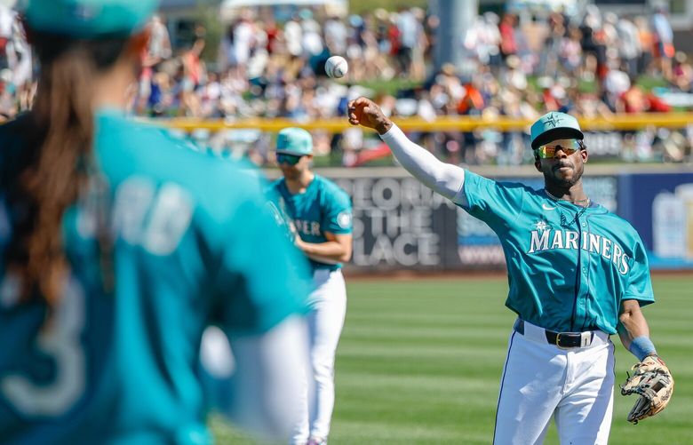 Ryabn Bliss warms up with J.P. Crawford before the start of Sunday’s game with the Arizona Diamondbacks.  The Arizona Diamondbacks played the Seattle Mariners in Spring Training Baseball Sunday, Feb. 23, 2025 at the Peoria Sports Complex, in Peoria, AZ. 229387