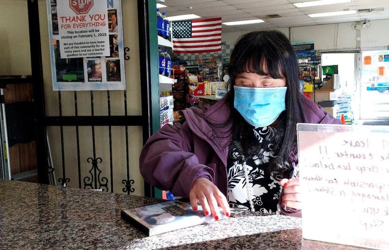 Christina Cavanaugh pays for a video rental at Kraning’s store. (MUST CREDIT: Toni Cavanaugh)