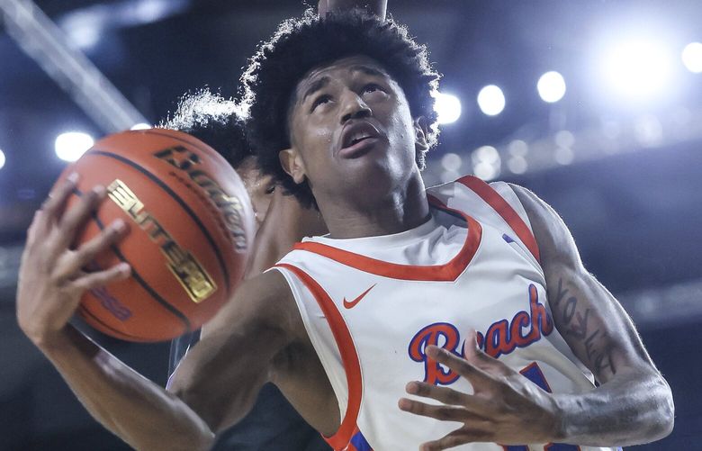Rainier Beach’s Jaylen Petty goes up and under for a shot attempt Friday night during the Class 3A semifinals Washington State Basketball Tournament in Tacoma, Washington, on March 7, 2025. Rainier Beach won 59-47 to advance to the championship game. 229452