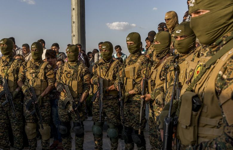 FILE — Syrian Democratic Forces fighters during a funeral in Kobane, Syria, Oct. 14, 2017. The Kurdish-led militia that controls northeast Syria agreed on Monday, March 10, 2025, to merge with the country’s new government, marking a major breakthrough for Damascus in its efforts to unify a country wrestling with violent turmoil. (Ivor Prickett/The New York Times) XNYT0749 XNYT0749