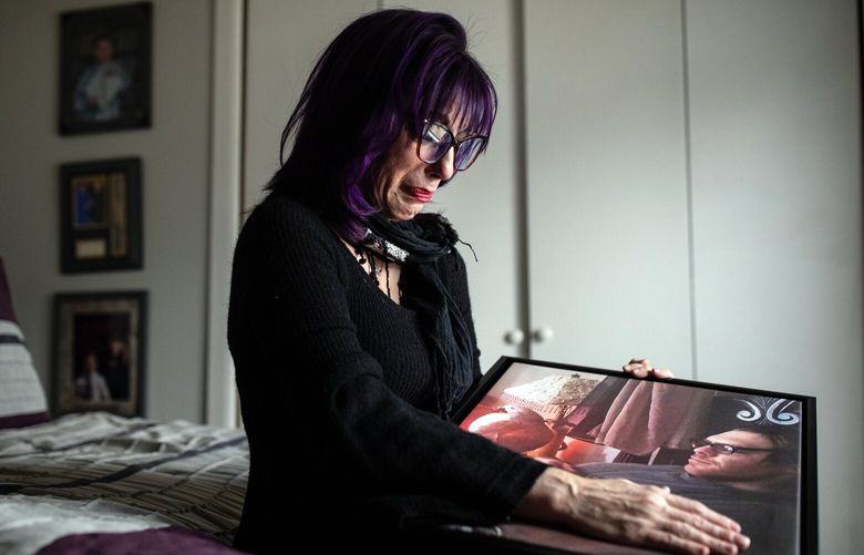 Ruth Scott cries while looking at a portrait of her son, Mikael, while sitting in his bedroom at her home in Schertz, Texas, on Jan. 27, 2022. Scott has filed a wrongful death suit after Mikael Scott killed himself using a food preservative he bought on Amazon. (Tamir Kalifa/The New York Times) XNYT104