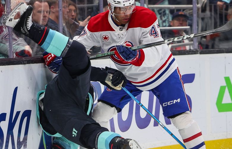 Montreal’s Jayden Struble (47) puts Seattle’s Mikey Eyssimont into the boards behind the Canadien crease in the first period.    The Montreal Canadiens played the Seattle Kraken in NHL Hockey Wednesday, March 12, 2025 at Climate Pledge Arena, in Seattle, WA. 229462