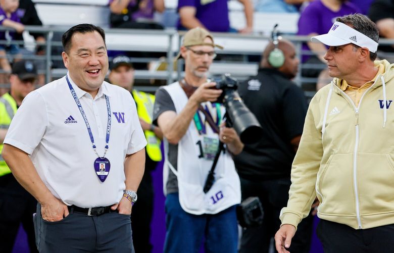 Washington Huskies head coach Jedd Fisch, right, chats with athletic director Pat Chun before the start of a game against the Weber State Wildcats Saturday, Aug. 31, 2024 in Seattle. 227896