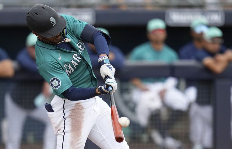 Seattle Mariners’ Julio Rodríguez connects for a grand slam against the Kansas City Royals during the second inning of a spring training baseball game Wednesday, March 12, 2025, in Peoria, Ariz. (AP Photo/Ross D. Franklin) AZRF103 AZRF103