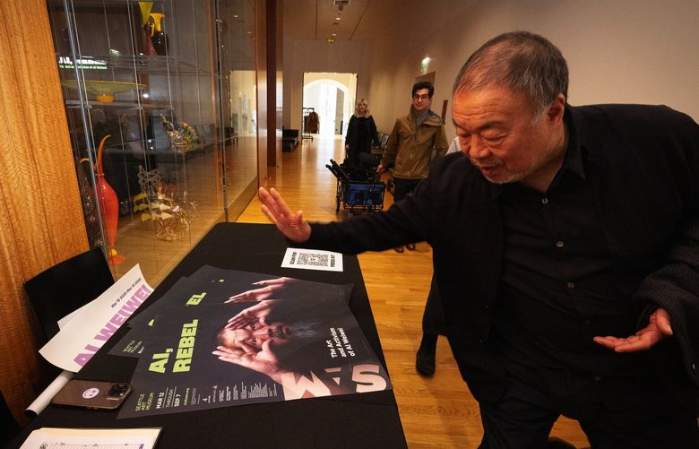 Ai Weiwei reacts to his image on the Seattle Art Museum poster for his major restrospective “Ai, Rebel: The Art and Activism of Ai Weiwei,” Friday, March 7, 2025, in Seattle. The show runs March 12 to September 7, 2025.