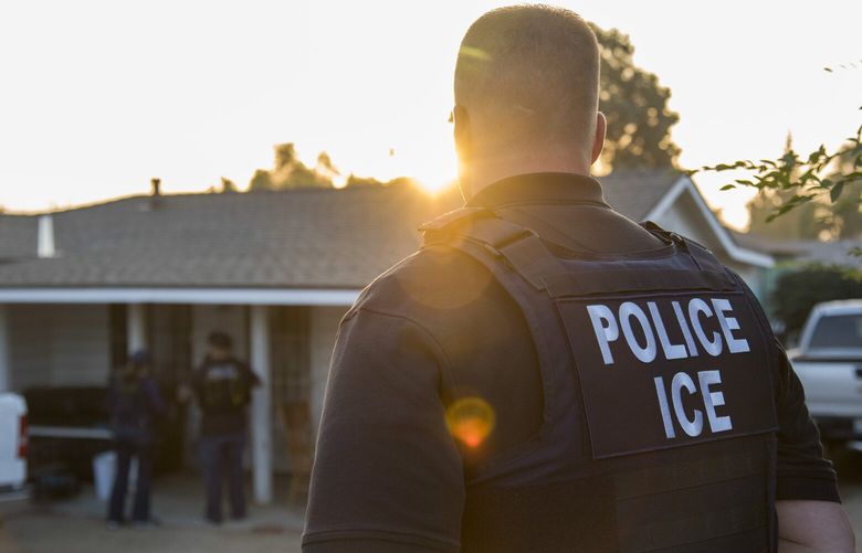 FILE — A U.S. Immigration and Customs Enforcement agent outside of a home in Riverside, Calif., on June 22, 2017. The Alien Enemies Act of 1798 gives the president wartime powers to deport undocumented immigrants with little to no due process. (Melissa Lyttle/The New York Times) XNYT0109 XNYT0109