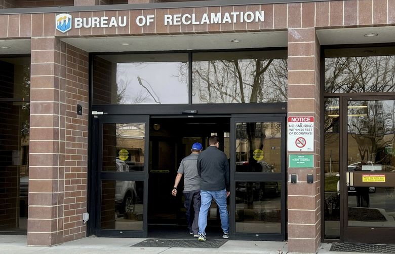 Workers enter the Bureau of Reclamation office Thursday, March 13, 2025, in Boise, Idaho. (AP Photo/Rebecca Boone) RPRB103 RPRB103