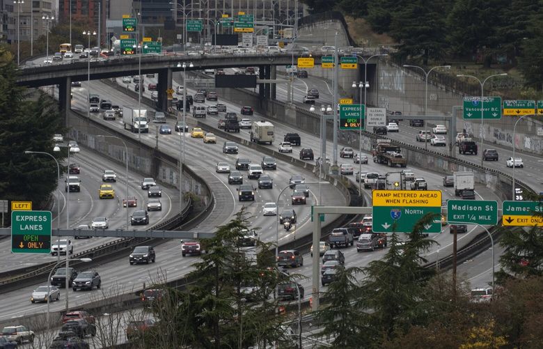 Traffic at center of frame leading to lower left corner travels southbound on I-5 Friday, October 18, 2024. Overpass at top is Yesler Way. 228393