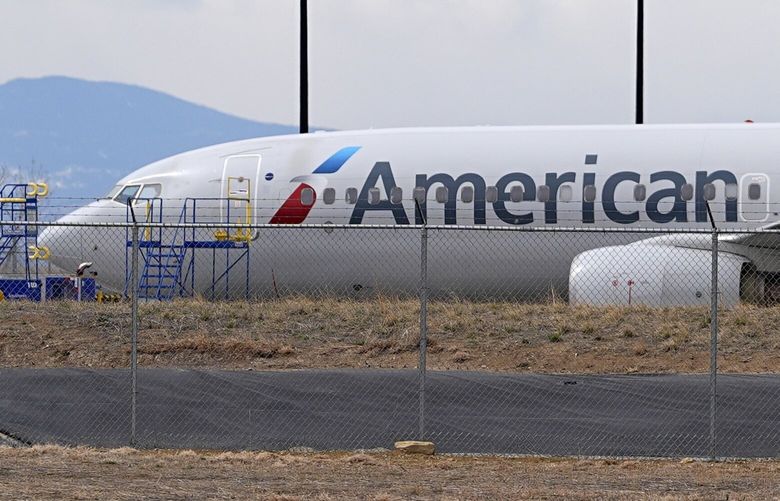 An American Airlines jetliner that caught fire after landing Thursday at Denver International Airport sits near a hangar at the airport Friday, March 14, 2025, in Denver. (AP Photo/David Zalubowski) CODZ102 CODZ102