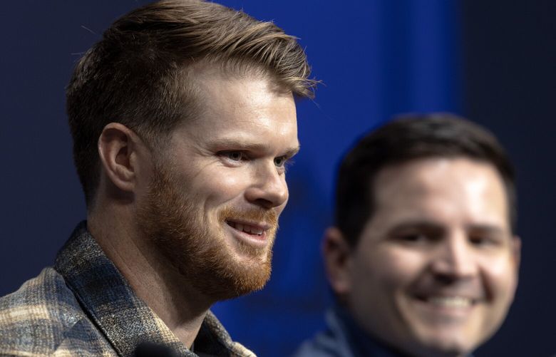 Sam Darnold, the Seahawks’ new quarterback, speaks as head coach Mike Macdonald listens during a press conference on Thursday, March 13, 2025, in Renton.