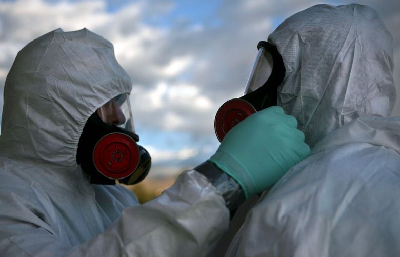 FILE – Workers at the Los Alamos National Laboratory nuclear site in New Mexico prepare to clean up a demolished building on Oct. 8, 2009. Firings and buyouts hit the top-secret National Nuclear Security Administration amid a major effort to upgrade America’s nuclear arsenal. Critics say it shows the consequences of heedlessly cutting the federal work force. (Mark Holm for The New York Times) XNYT0968