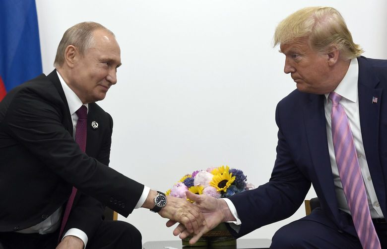 FILE – President Donald Trump, right, shakes hands with Russian President Vladimir Putin, left, during a bilateral meeting on the sidelines of the G-20 summit in Osaka, Japan, June 28, 2019. (AP Photo/Susan Walsh, File) WX201 WX201