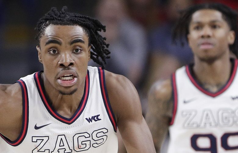 Gonzaga guard Michael Ajayi, right, controls the ball while pressured by Long Beach State forward Derrick Michael Xzavierro during the second half of an NCAA college basketball game, Wednesday, Nov. 20, 2024, in Spokane, Wash. (AP Photo/Young Kwak)