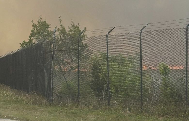 This photo provided by shows smoking from fires on Miami-Dade side fill the sky on Card Sound Road heading to the Florida Keys on Tuesday, March 18, 2025.  (Monroe County Board of County Commissioners via AP) 
 FLPD102 FLPD102