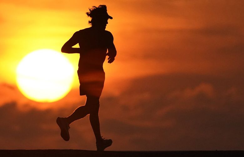 FILE – A jogger is silhouetted while running on a jetty at sunrise over the Atlantic Ocean in Bal Harbour, Fla., on Sept. 19, 2020. (AP Photo/Wilfredo Lee, File) NYCL401 NYCL401