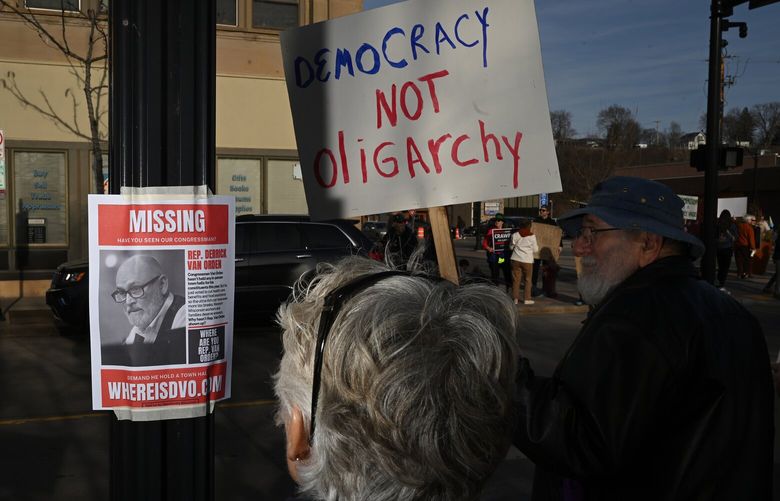 A flier labeling Rep. Derrick Van Orden as “missing” is posted on a light pole outside Eau Claire’s federal building during the March 12 protest. MUST CREDIT: Joshua Lott/The Washington Post