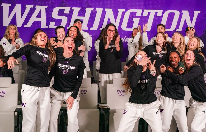 The Washington women’s basketball team celebrates after hearing it will play in the NCAA tournament.