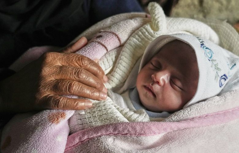 Ella Osama Abu Dagga, 25 days old, is held by her great-aunt Suad Abu Dagga, after she was pulled from the rubble earlier following an Israeli army airstrike that killed her parents and brother, in Khan Younis, southern Gaza Strip, Thursday, March 20, 2025. (AP Photo/Abdel Kareem Hana ) XEM126 XEM126