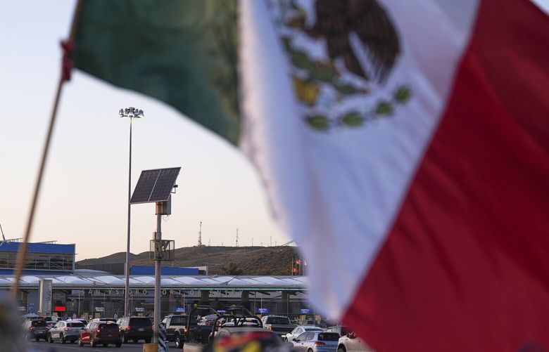 FILE – Vehicles wait in line to cross the border into the United States at the San Ysidro Port of Entry, Tuesday, March 18, 2025, in Tijuana, Mexico. (AP Photo/Gregory Bull, File) NYRL410 NYRL410