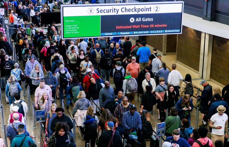 Passengers wait in line at Security Checkpoint 2 at Seattle-Tacoma International Airport Tuesday, May 14, 2024. Security Checkpoint 3 closed down Sunday, and will be closed about a month. Security Checkpoint 2 opened on Saturday, which had been closed for the previous month for reconfiguration. Both checkpoints are adding more lanes for security screening.  
 226909
