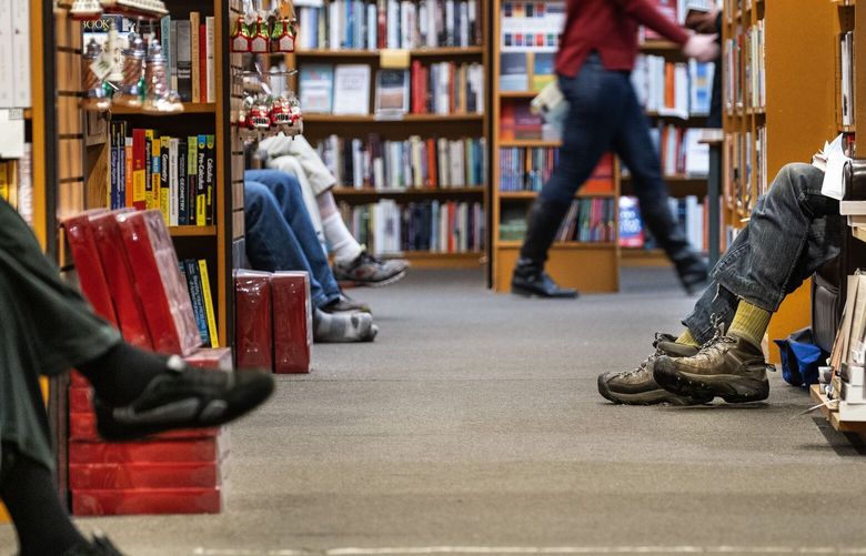 Comfortable easy chairs lead to comfortably crossed legs as patrons to Third Place Books have a leisurely date with paper.

Third Place Books in Lake Forest Park celebrated its 20th anniversary as a “third place” — that place that isn’t work or home, but where a community gathers.  Photographed Tuesday, December 11, 2018. 208675