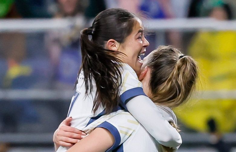Seattle Reign FC forward Emeri Adames jumps into the arms of forward Jordyn Huitema after Adames scored during the second half Saturday, March 15, 2025 in Seattle. 229494