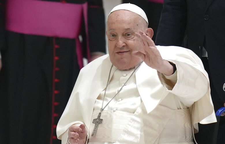 FILE – Pope Francis waves as he arrives for his weekly general audience in the Paul VI Hall, at the Vatican, Wednesday, Feb. 12, 2025. (AP Photo/Alessandra Tarantino, File) ALT105 ALT105
